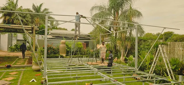 Zinc-plated steel tent frames and deck sections being assembled