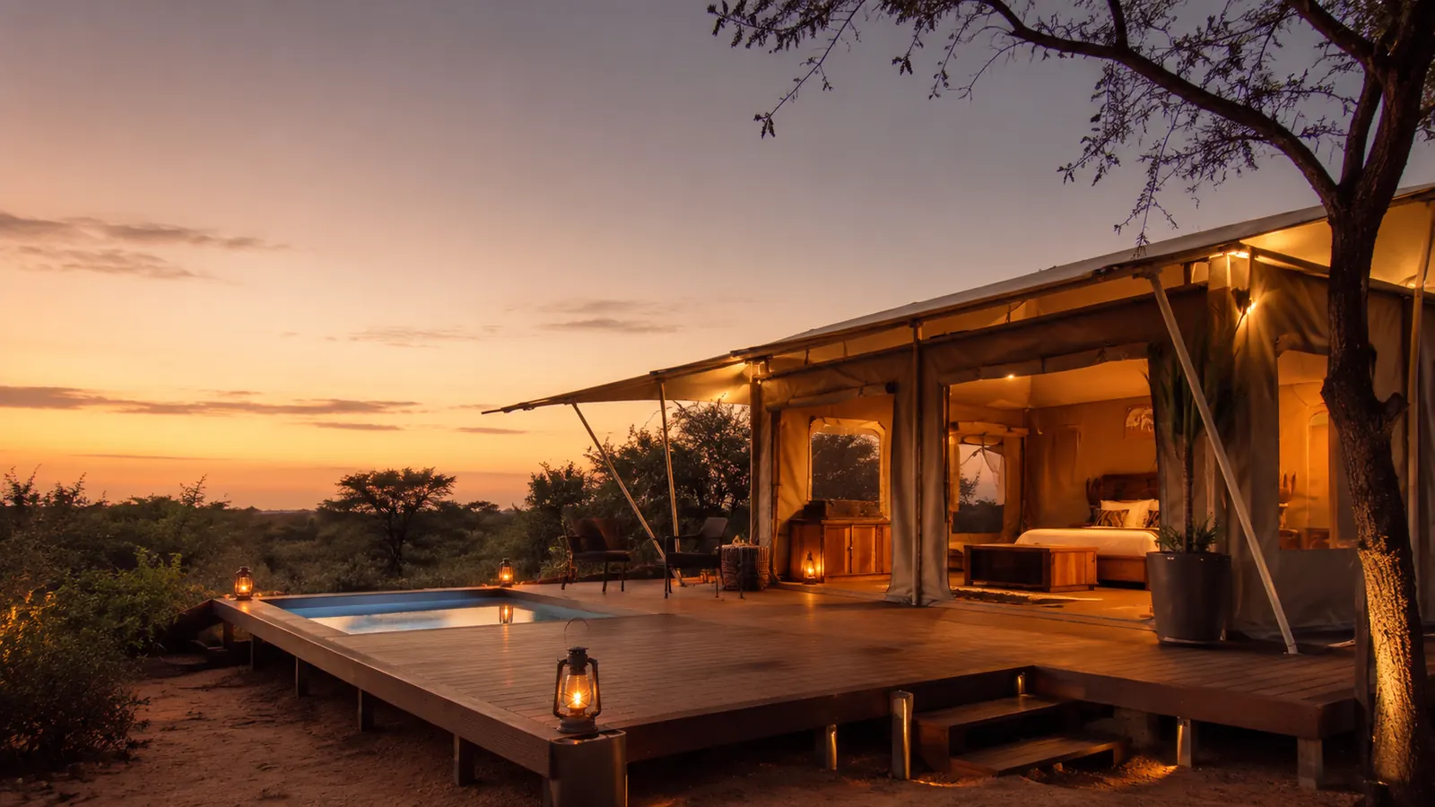 Tented lodge suite with deck and plunge pool at dusk
