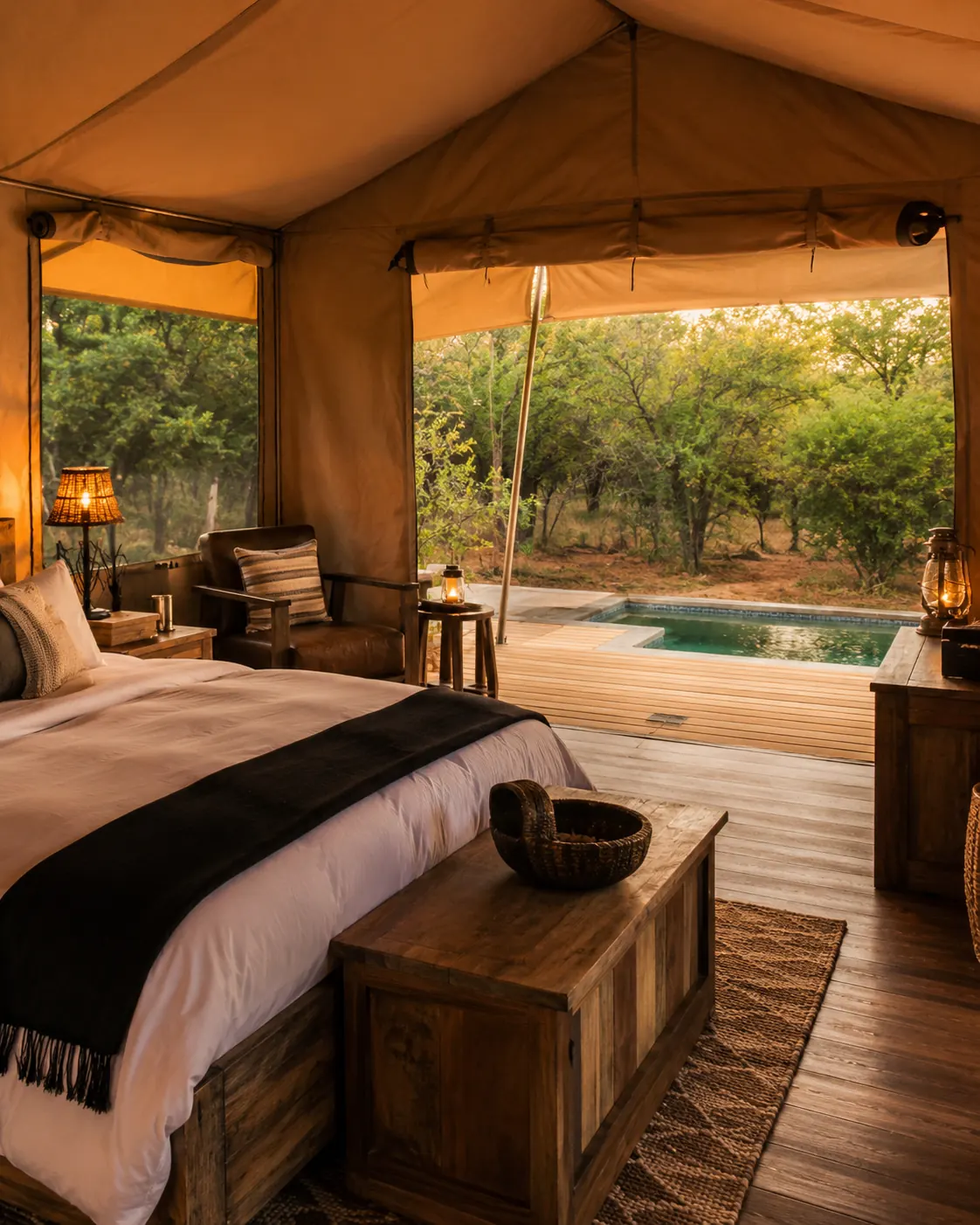 Safari tent bedroom looking out over the deck and plunge pool