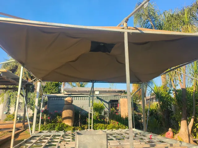 Zinc-plated steel safari tent frame with canvas roof during installation